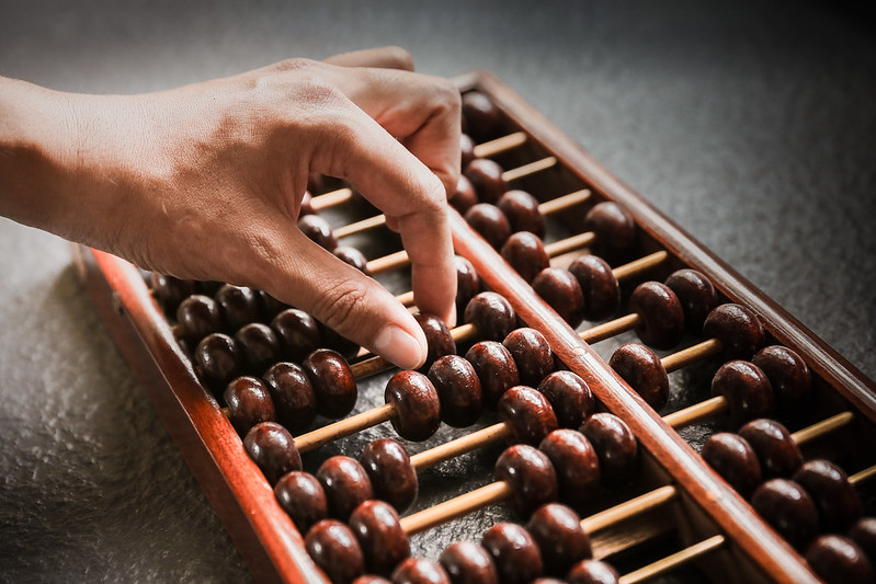 Hand counting with wooden abacus