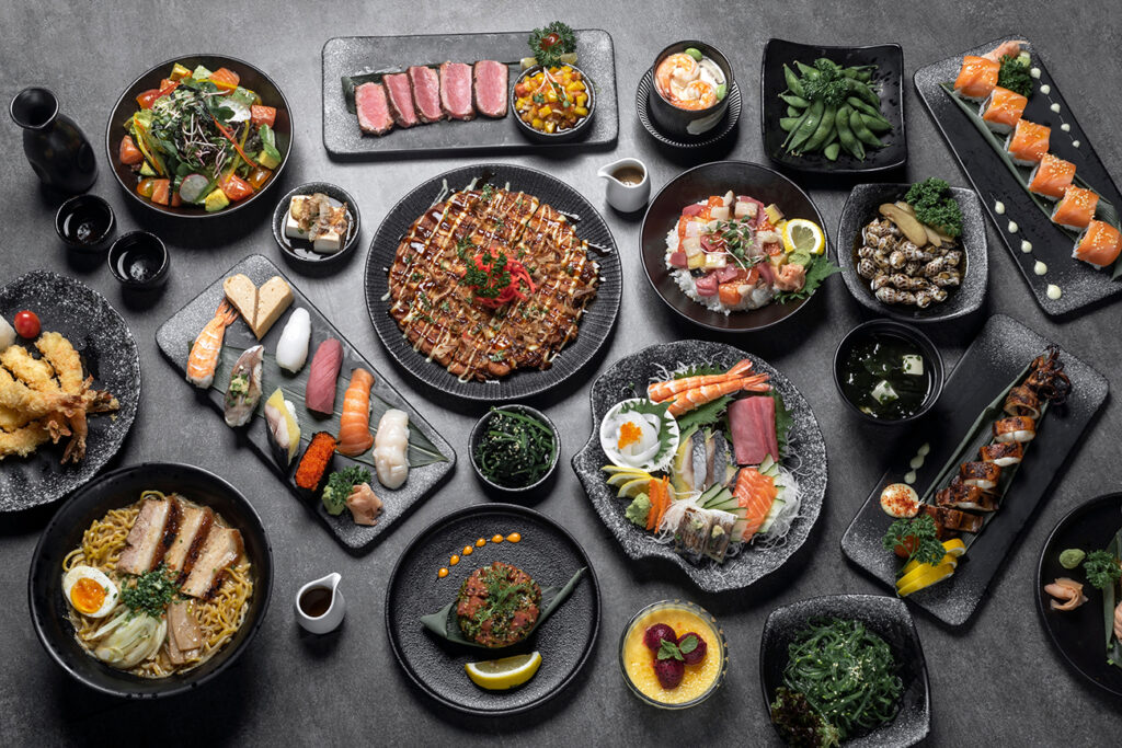 many traditional gourmet japanese food dishes variety on grey background