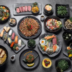 many traditional gourmet japanese food dishes variety on grey background