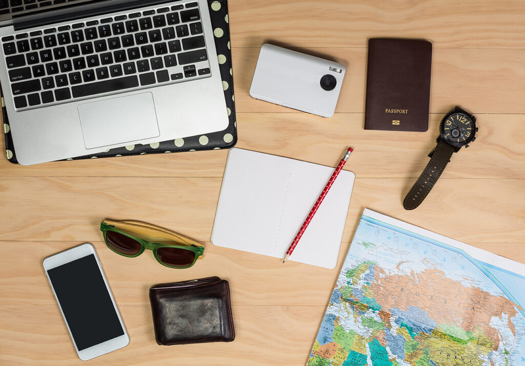 top view of travel items on wooden table