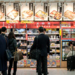 OSAKA, JAPAN - JAN 20, 2020: Passenger searching for Bento lunch box, known as "Ekiben" (Bento from railway stations) from a store displaying large variety of bento in Shin-Osaka station